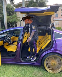 a purple and gold car with a door open