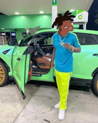 a man with dreadlocks standing next to a green car